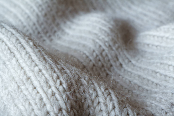 Extreme close-up gray color knitted sweater made of natural wool texture, wavy folds, selective focus - Photo, Image
