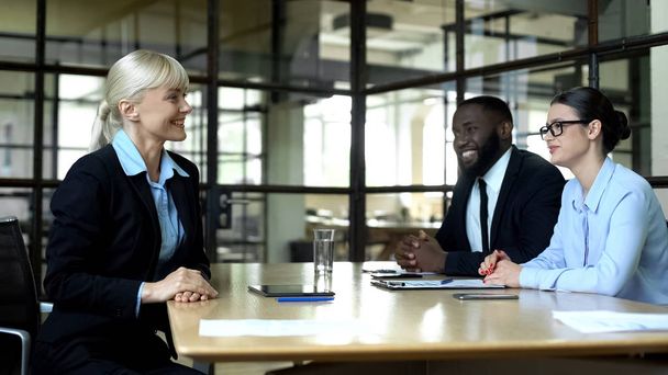 Blond business woman smiling at partners, meeting in office, successful career - Photo, Image