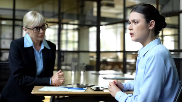 Scared woman at job interview with strict lady boss, business career development - Foto, Bild