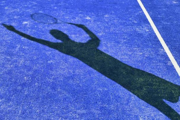 Shadow of tennis player getting ready to hit ball - Photo, Image