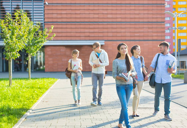 Students walking outside university campus - Fotoğraf, Görsel