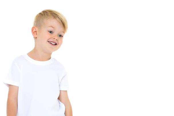 Emotional little boy in a pure white t-shirt. - Zdjęcie, obraz