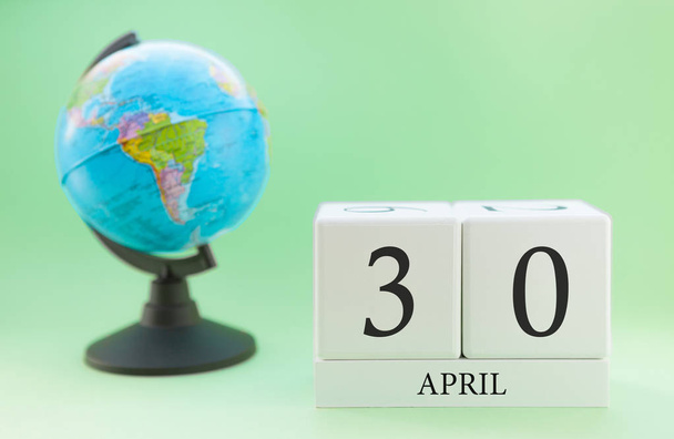 Planner wooden cube with numbers, 30 day of the month of April, spring - Fotoğraf, Görsel