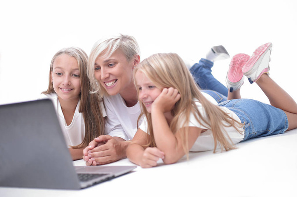 mom and daughters watching their favorite video on a laptop - Fotó, kép
