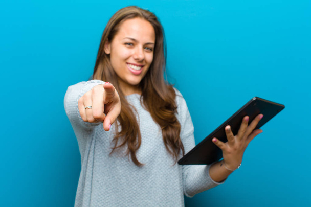 young woman with a tablet against blue background - Foto, Bild