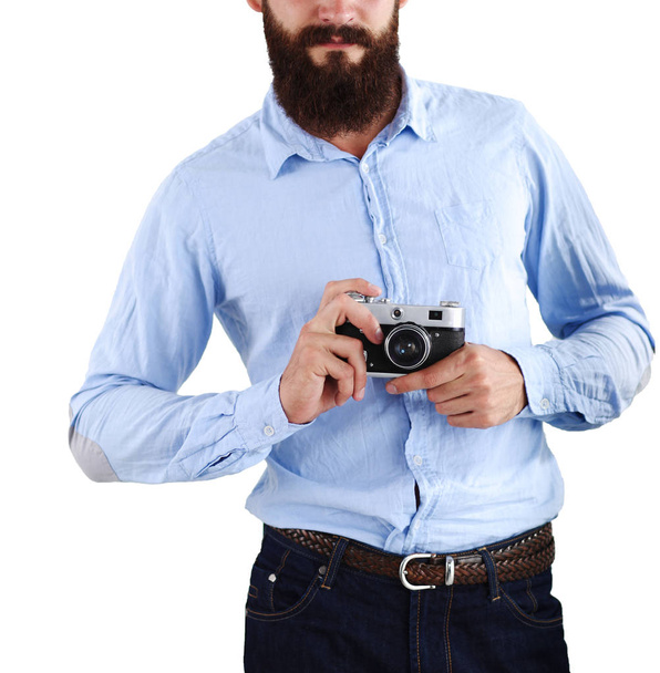 A portrait of a young photographer with a camera, isolated on white background - Foto, Bild