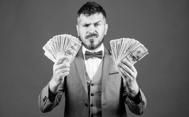 Gain real money. Richness and wellbeing concept. Cash transaction business. Easy cash loan. Man formal suit hold many dollar banknotes blue background. Businessman got cash money. Take my money - Foto, Imagen