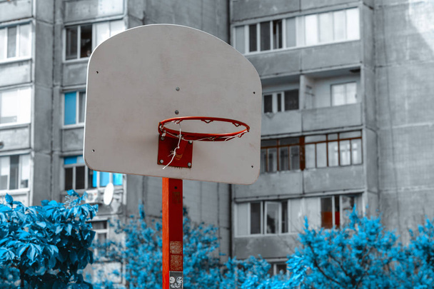 Anel de basquete isolado com malha de metal no fundo da casa. Vista urbana. Conceito de desporto
  - Foto, Imagem