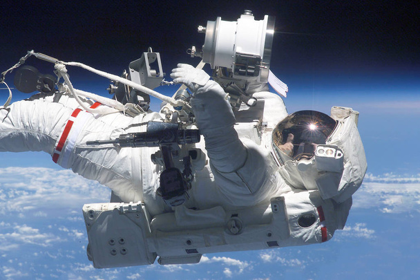 Astronaut in a spacesuit at the space station. Elements of this image were furnished by NASA - Photo, Image