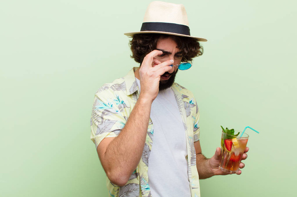 young crazy bearded man with a cocktail. tourist concept - Photo, image