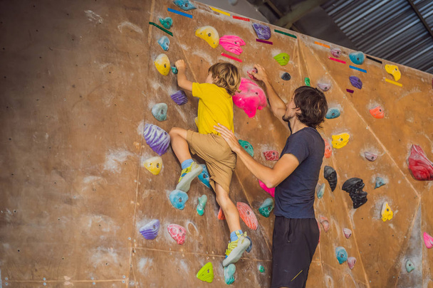 Dad and son at the climbing wall. Family sport, healthy lifestyle, happy family - Photo, Image