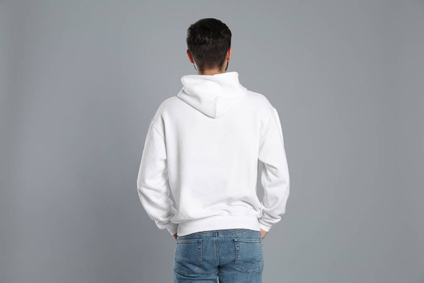 Young man in sweater on grey background. Mock up for design - Photo, Image