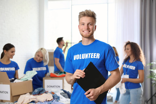 Portrait of happy male volunteer in uniform indoors - Photo, Image