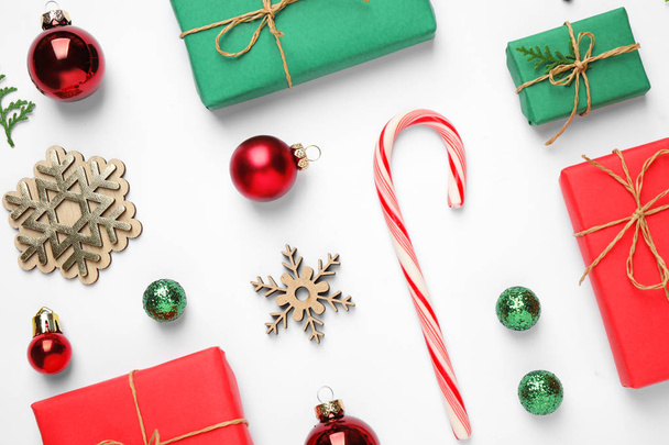 Flat lay composition with Christmas gifts and festive decor on white background - Photo, Image