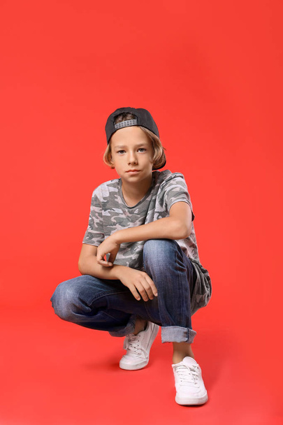 Cute little boy in casual outfit on red background - Photo, Image