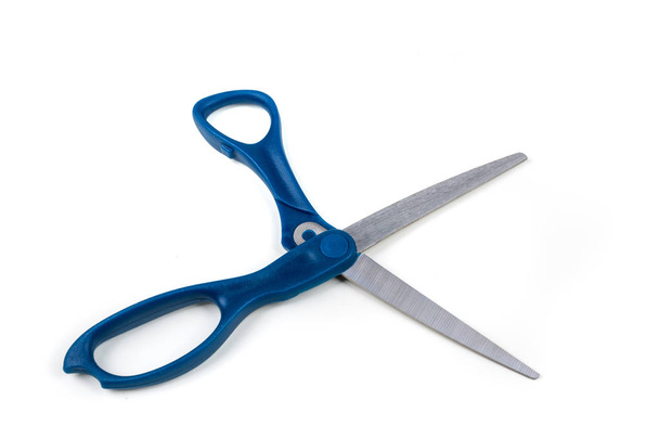 Blue handled pair of metal scissors on a white background - Photo, Image