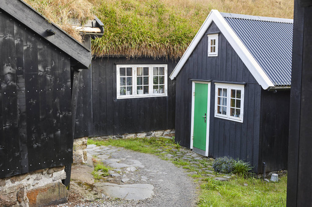 Tradycyjne Wyspy Owcze drewniane czarne domy z trawą dach murawy - Zdjęcie, obraz