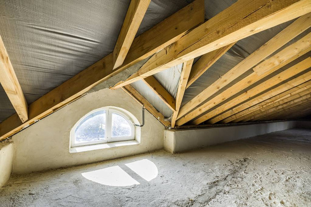 Attic of a building with wooden beams of a roof structure and a  - Photo, Image