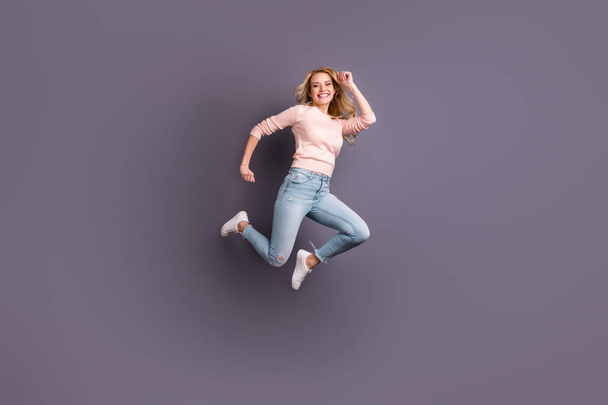 Full body photo of pretty lady jumping high competitive sportive mood wear casual stylish outfit isolated grey color background - Fotó, kép