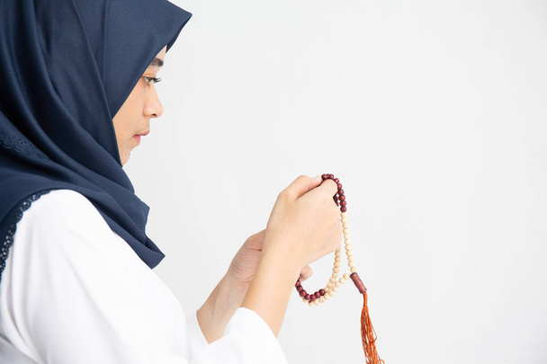 Silhouette young female muslim prayer with hijab praying to God  - Фото, изображение