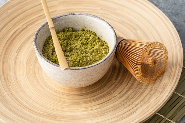Japanese matcha green tea powder, a healthy natural product, antioxidant. Bamboo spoon and whisk. - Fotoğraf, Görsel