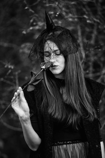 Black and white portrait of a widow with a dar rose, Halloween theme - Zdjęcie, obraz