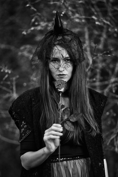 Black and white portrait of a widow with a dar rose, Halloween theme - Foto, afbeelding