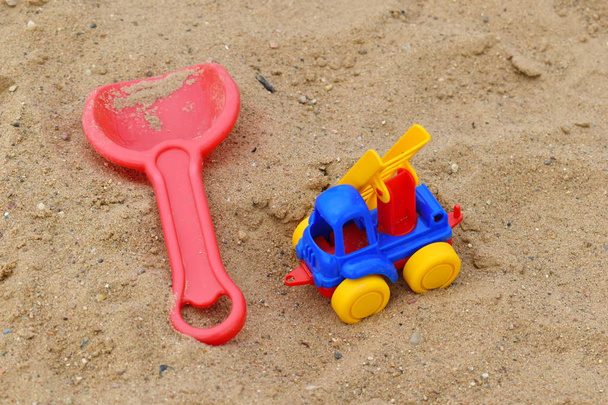 little plastic toys in the sand. - 写真・画像