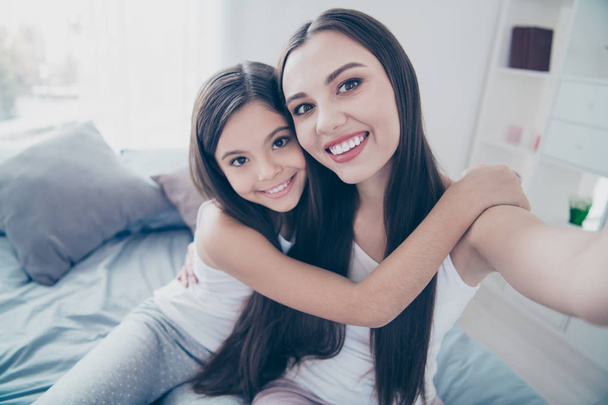 Self-portrait of two nice beautiful attractive lovely charming cute tender sweet affectionate cheerful cheery people bonding embracing spending holiday in light white interior room indoors - Fotoğraf, Görsel