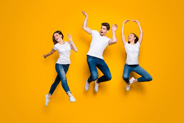 Full length body size view of three nice attractive lovely cute slim sporty cheerful cheery adorable person buddy fellow having fun free time isolated over bright vivid shine yellow background - Valokuva, kuva
