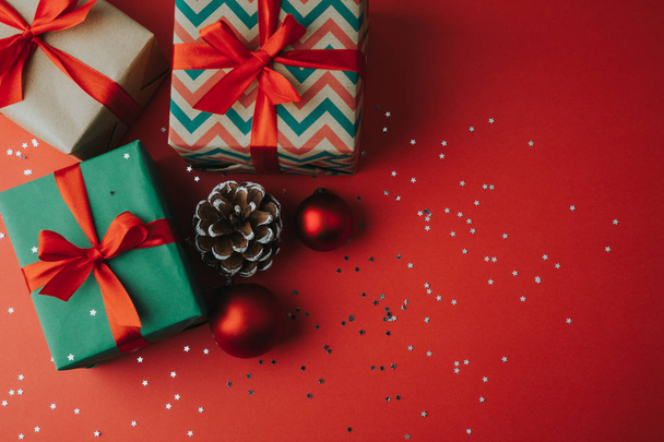 Christmas presents and ornaments on a red background - Foto, Imagem