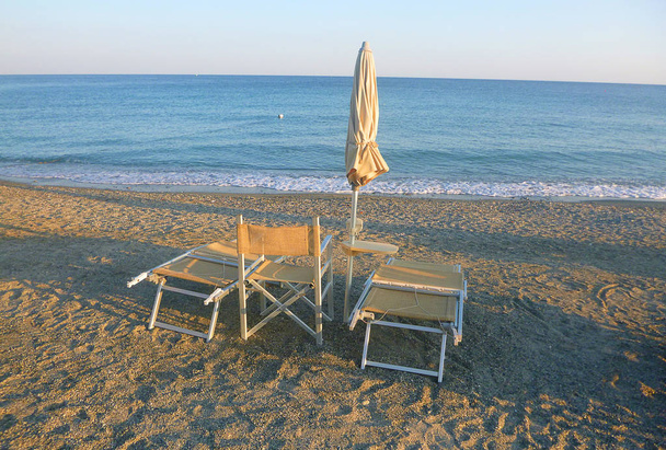 deck chairs on the sand in front of the sea - Photo, Image