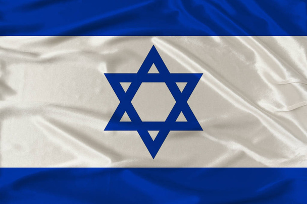 national flag of the country of Israel on gentle silk with wind folds, travel concept, immigration, politics, copy space, close-up - Photo, Image