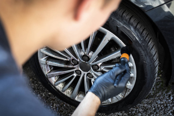 Car wash. Cleaning aluminum wheels. Car washing. - Photo, Image