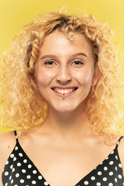 Caucasian young womans close up portrait on yellow background - Photo, image