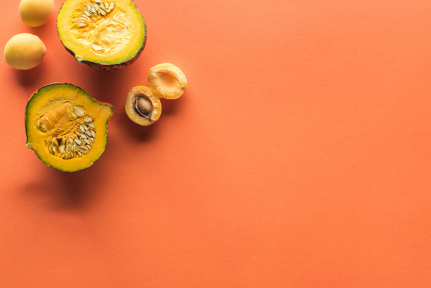 top view of yellow apricot and pumpkin on orange background with copy space - Foto, immagini