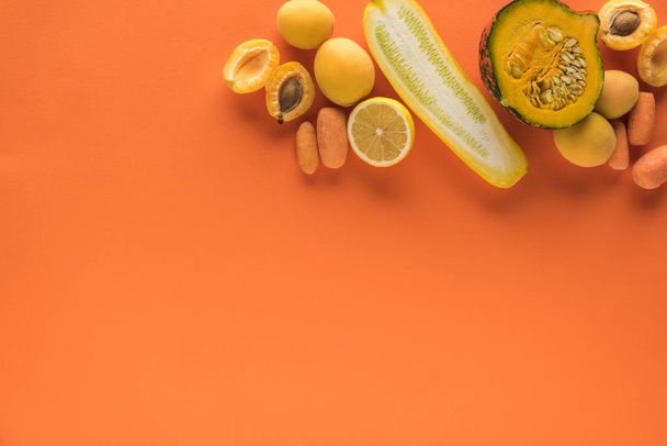 top view of yellow fruits and vegetables on orange background with copy space - Fotografie, Obrázek