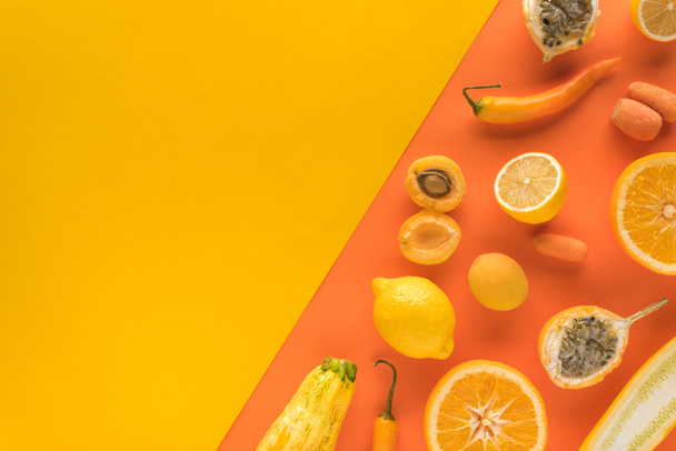 top view of delicious fruits and vegetables on yellow and orange background with copy space - Photo, Image