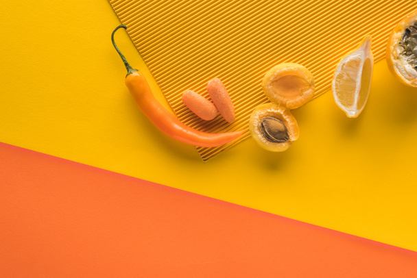 top view of fresh fruits and vegetables on yellow and orange background with copy space - Фото, зображення