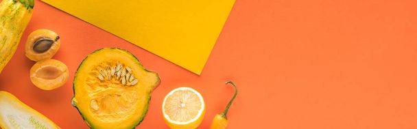 top view of yellow fruits and vegetables on orange background with copy space, panoramic shot - Foto, afbeelding