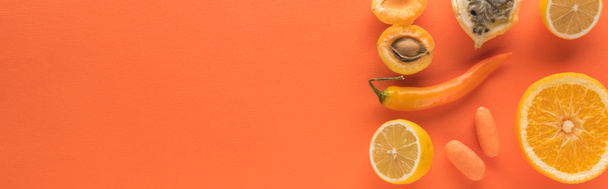 top view of yellow fruits and vegetables on orange background with copy space, panoramic shot - Photo, Image