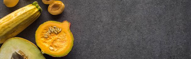 top view of yellow fruits and vegetables on grey textured background with copy space, panoramic shot - Foto, afbeelding