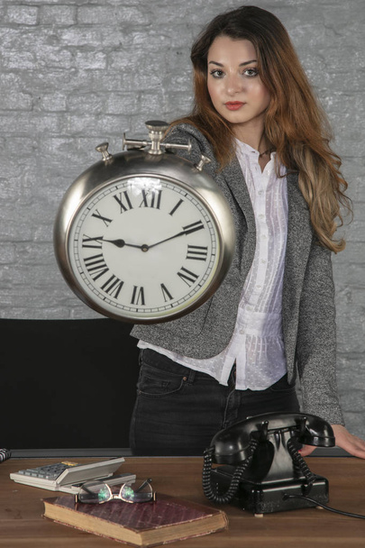 business woman shows a big clock - Zdjęcie, obraz