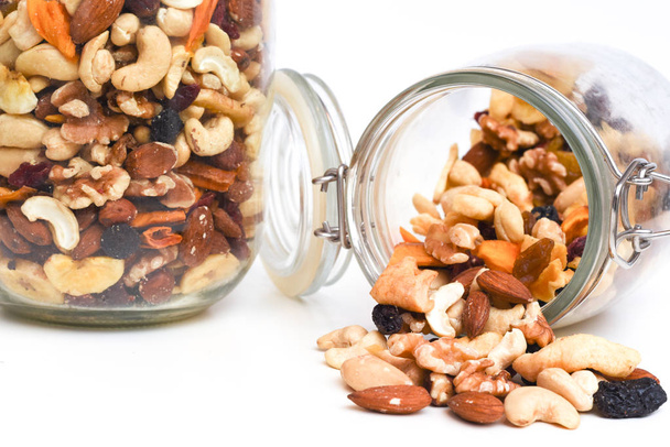 Healthy snack food trail mix of mixed nuts and dried fruits - Photo, Image