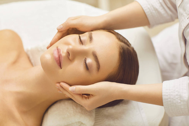 Face woman massage relax close up in a beauty clinic. - Foto, Imagem