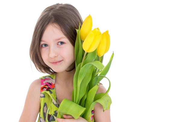 Little girl with a bouquet of flowers.Concept of holiday, summer - Foto, Imagem