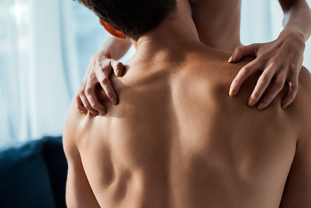 cropped view of passionate woman scratching back of man - Foto, Imagen
