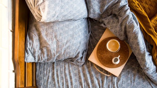 Černá káva v průhledném hrnku v posteli na podzimním ránu - Fotografie, Obrázek