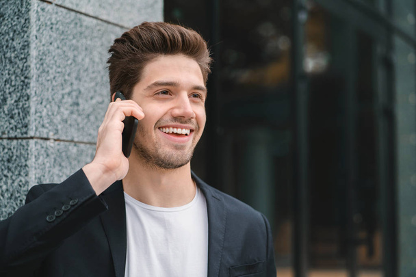 Close up portrait of businessman have conversation using mobile phone. Business guy in formal suit gladly talks with colleague. Office employee, wage worker, weekdays concept - Foto, Imagen