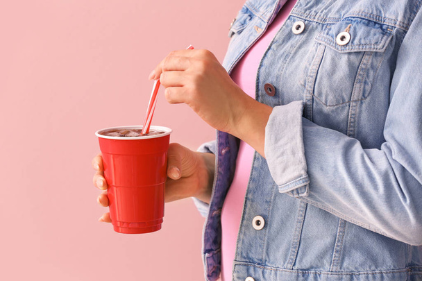 Woman with cup of cola on color background, closeup - Fotó, kép
